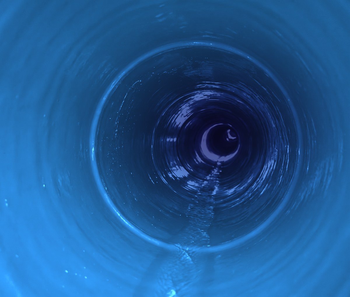 Inside a relined sewer pipe, smooth and sealed end to end